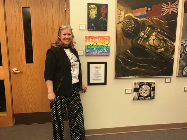 Ms. G poses with the artwork